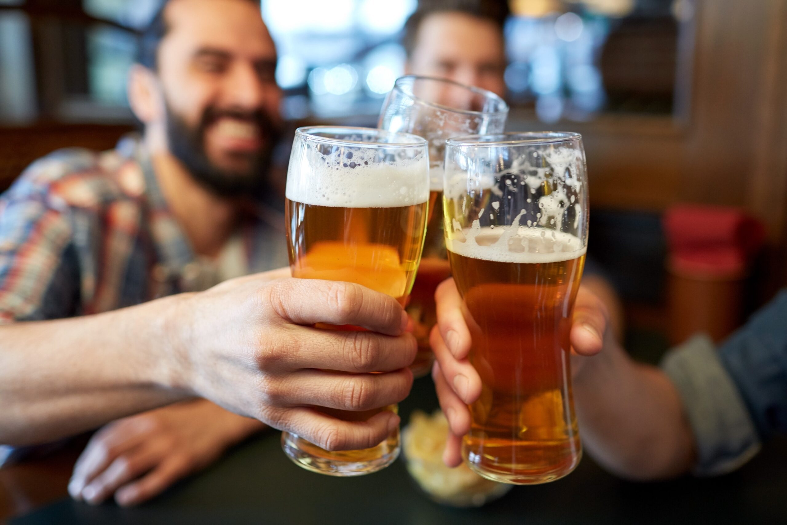 Men at the pub with pints of beer